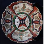 Japanese Imari porcelain petal rimmed charger with reserved decorative panels depicting stylised