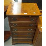 Reproduction yew wood narrow straight front chest of six drawers on bracket feet. (B.P. 24% incl.