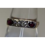 A 14ct gold four stone ring with rubies and diamonds. (B.P. 24% incl.