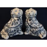 Pair of reproduction Staffordshire type blue and white decorated pottery dogs. 28cm high approx.