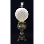 Early 20th Century brass double burner oil lamp with glass reservoir on a bronzed metal base,
