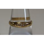 An 18ct gold and tiny diamond ring. Weight 3g approx. (B.P. 24% incl.