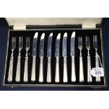 Cased set of six + six silver handled dessert knives and forks.