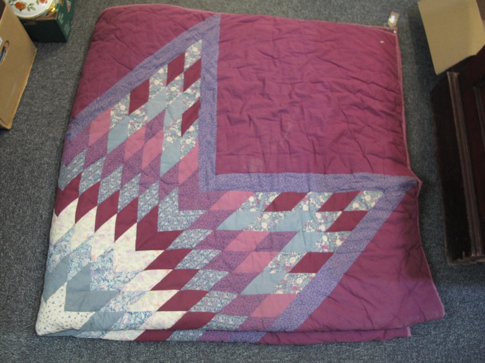 A purple ground vintage patchwork quilt with star design and patch embroidered Ameke 1903 to the