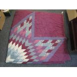 A purple ground vintage patchwork quilt with star design and patch embroidered Ameke 1903 to the