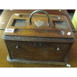 Early 20th Century oak stationery box and ink stand with pull out compartments and plated shield