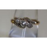 An 18ct gold and diamond three stone ring on a twist. Weight 3.2g approx. (B.P. 24% incl.