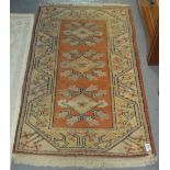 Small Turkish salmon and beige ground rug with three tarantula guls. (B.P. 24% incl.