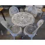 Circular garden pierced metal table with under tier, together with four matching garden chairs.
