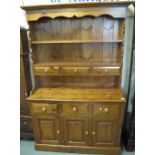 Modern pine two stage rack back dresser with fitted spice drawers on a platform base. (B.P.
