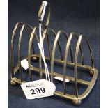 Silver six division pointed arch toast rack with loop handle on ball feet. Sheffield hallmarks, 4.