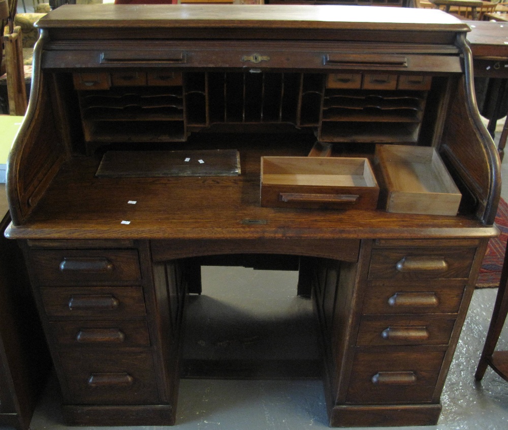 Early 20th Century oak 'S' roll tambour front twin pedestal desk. (B.P. 24% incl.