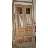 Pair of French stripped pine doors with wrought iron grills and outer framing. (B.P. 24% incl.