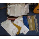 Box of fabric and tableware to include; crochet table mats, woven banded woollen fringed table mats,