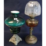 Brass single burner oil lamp with glass reservoir on cast metal base, coloured glass shade.