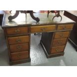 Edwardian knee hole desk having leather inset top with three drawers to each pedestal on a platform