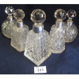 Pair of globular shaped cut glass scent bottles with prismatic stoppers,