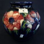 Moorcroft art pottery baluster shaped vase with overall tube lined decoration of anemones.