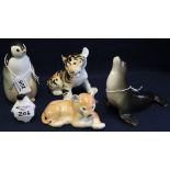 A group of Russian china animal figures to include; lion cub, tiger cub, two penguins and a seal.