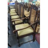 A set of six early 20th Century oak dining chairs having cane backs and bobbin turned supports on