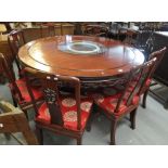 Chinese hardwood circular pedestal dining table having glass lazy susan and dragon carved pierced