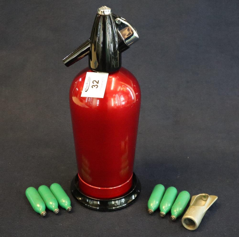 A Sparklets soda syphon on stand, together with compressed air capsules. (B.P. 24% incl.