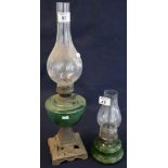 Brass single burner oil lamp with glass reservoir on cast metal base with clear chimney,