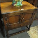 Mid 20th Century oak old charm style two door blind panelled cupboard on stretcher supports. (B.P.