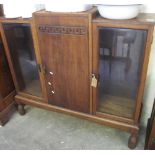 Mid 20th Century oak glazed cabinet with blind central door. (B.P. 24% incl.