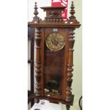 Early 20th Century walnut two train Vienna type wall clock with horse mount, pendulum and key. (B.P.