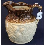 19th Century pottery baluster shaped relief moulded topers jug with two tone glazing.