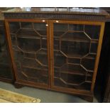 Early 20th Century mahogany astragal glazed two door display or bookcase cabinet on bracket feet.