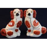 Pair of late 19th Century Staffordshire pottery red and white seated spaniels with painted features.