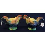 Two similar Staffordshire pottery hen shaped teapots with coloured foliage and printed marks to