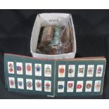 Box with various stamps in junior albums, a few presentation packs, tin of stamps,