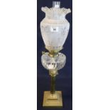 Brass double burner oil lamp with cut glass reservoir on fluted pedestal with stepped square base,