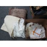 A box of vintage textiles to include; a cream fringed woollen blanket,