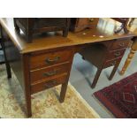 Early 20th Century oak knee hole desk having three drawers to each pedestal on square legs. (B.P.