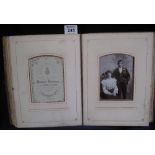 Victorian photograph album with moulded figural and leather bindings, brass clasp,