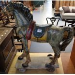 Unusual papier mache polychrome child's pull along horse on wooden base and wheels. (B.P. 24% incl.