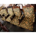 Four similar Art Nouveau design carved and upholstered foliate armchairs on turned legs and casters.