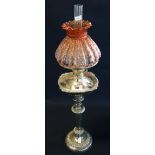 Silver plated vase-shaped oil lamp with moulded coloured shade and clear chimney on circular