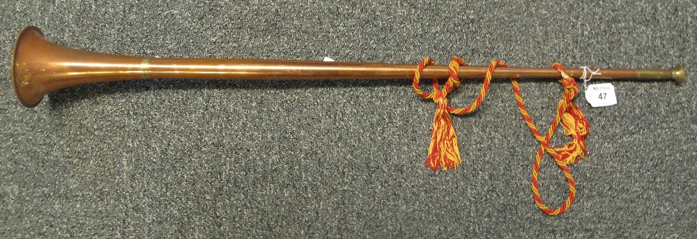 A copper and brass horn with tassel. (B.P. 24% incl.