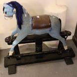 Small vintage polychrome painted wooden child's rocking horse on black painted frame and leather