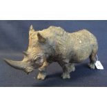 A carved wooden African study of a striding rhinoceros. (B.P. 24% incl.