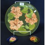 Moorcroft art pottery tube lined plate or charger on a green ground with floral and foliate