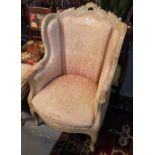 French style upholstered wing armchair with serpentine front on cabriole legs,