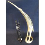 Horn sculpture of a stylised bird with long beak,