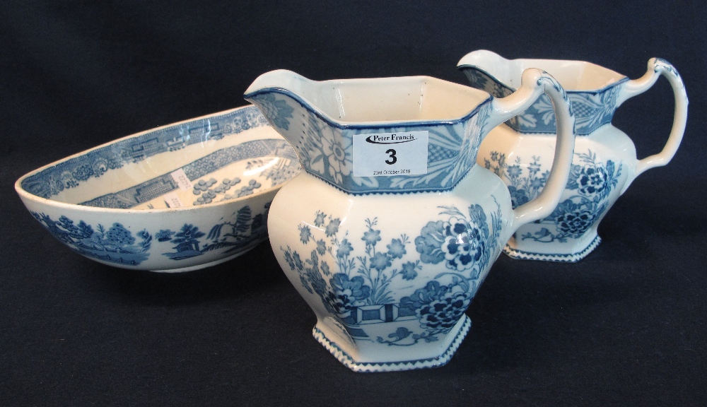 Two graduated blue and white transfer printed pouch shaped dresser jugs by Woods ware in the