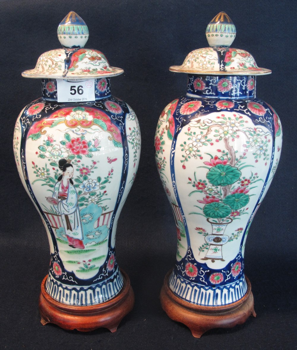 A pair of Japanese porcelain lidded vases,